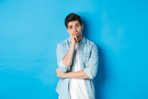 The 10 worst Self-Improvement mistakes - Honeyview unamused bored man looking without interest camera standing against bllue background 1 Honeyview unamused bored man looking without interest camera standing against bllue background 1