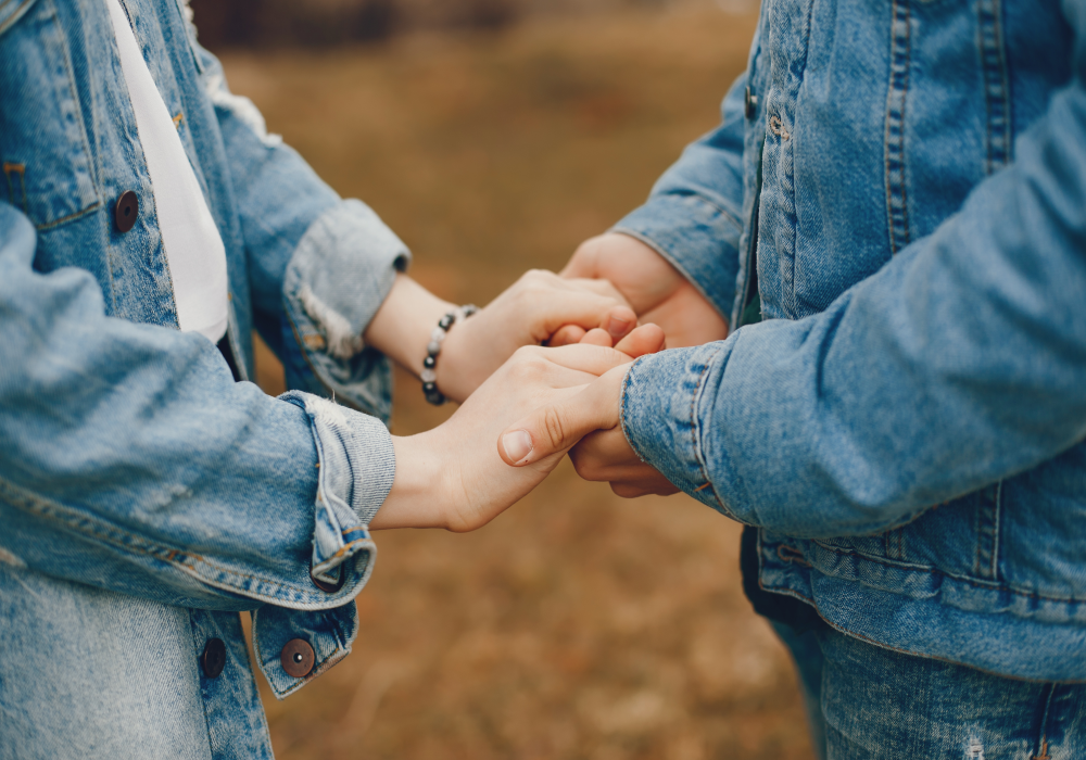 Two people holding hands